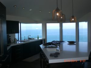 Oceanfront kitchen with pendant lighting over island