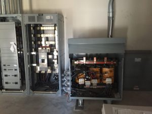 Open transformer cabinet next to distribution switchgear