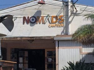 Nomads Canteen storefront with illuminated signage