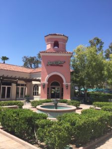 Plaza fountain and pink tower at a commercial center