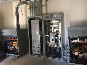 Main distribution panels and transformer in a commercial electrical room