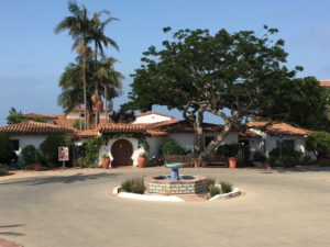 Spanish-style hacienda with tile roof and courtyard fountain